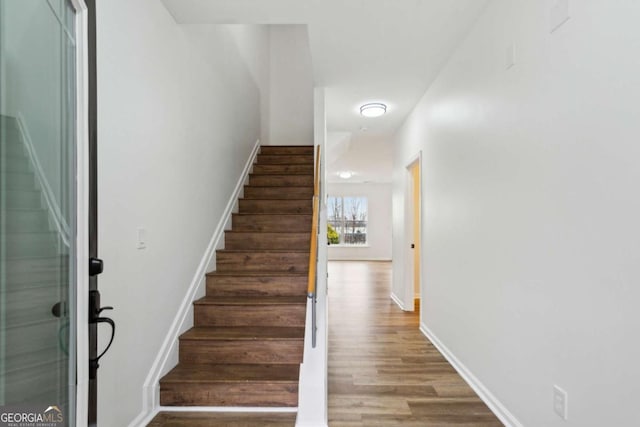 stairs featuring baseboards and wood finished floors