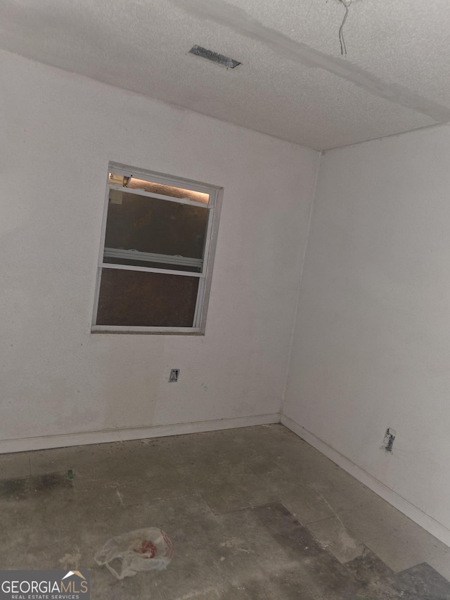 spare room with visible vents and a textured ceiling