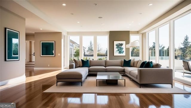 living area with recessed lighting, baseboards, and light wood finished floors