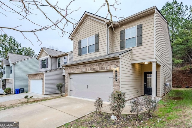 view of front of house with a garage, concrete driveway, and brick siding