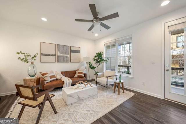 sitting room with a healthy amount of sunlight, recessed lighting, baseboards, and wood finished floors