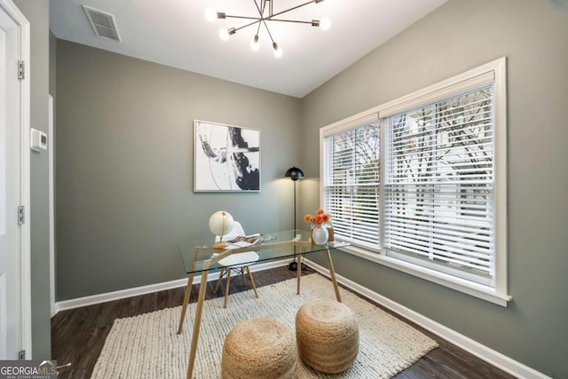 office space with visible vents, baseboards, an inviting chandelier, and wood finished floors