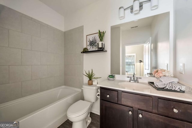 full bath with toilet, wood finished floors, vanity, and visible vents
