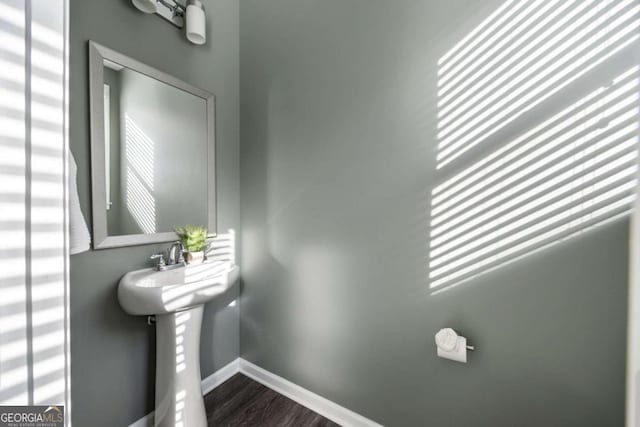 bathroom featuring baseboards and wood finished floors