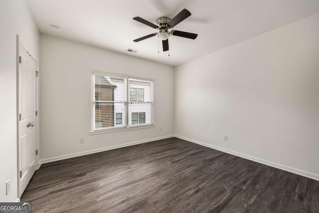 unfurnished bedroom with dark wood-type flooring, baseboards, a ceiling fan, and visible vents