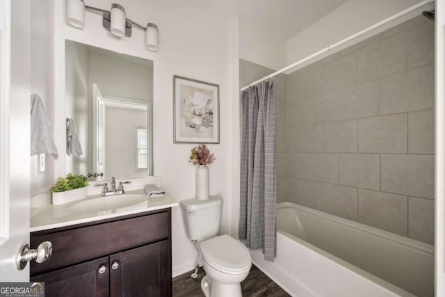 full bath featuring shower / tub combo with curtain, vanity, toilet, and wood finished floors