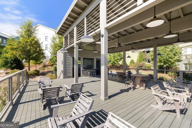 wooden terrace featuring ceiling fan and outdoor dining area