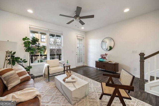 living area with a ceiling fan, recessed lighting, stairway, wood finished floors, and baseboards