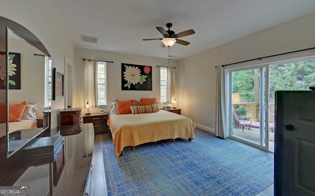 bedroom with access to exterior, a ceiling fan, visible vents, and wood finished floors