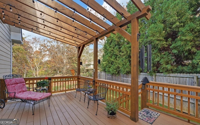 deck with a fenced backyard and a pergola