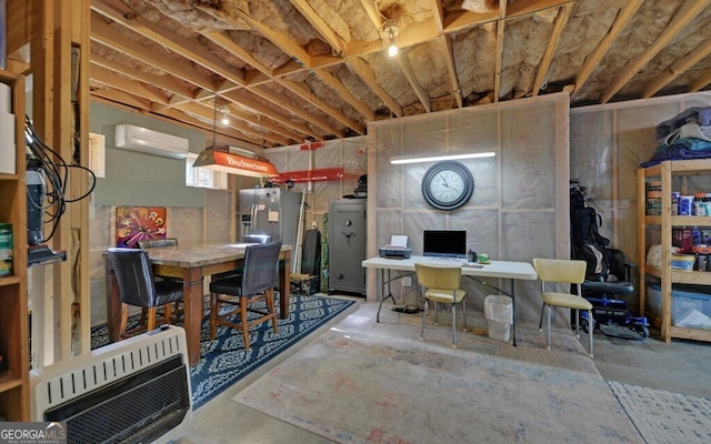 basement featuring heating unit, stainless steel fridge, and a wall mounted AC