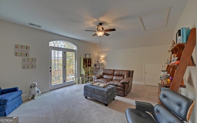 living area with baseboards, visible vents, french doors, and light colored carpet