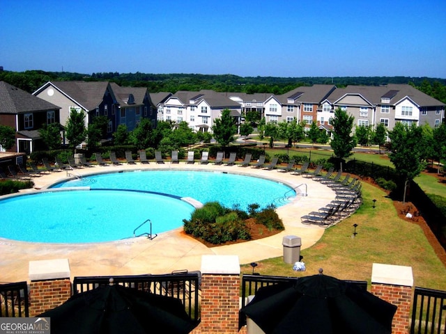 community pool featuring a patio area and a residential view