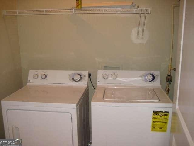 washroom with laundry area and washing machine and clothes dryer