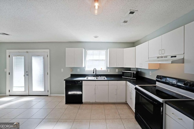 kitchen with dark countertops, white cabinets, under cabinet range hood, and black appliances