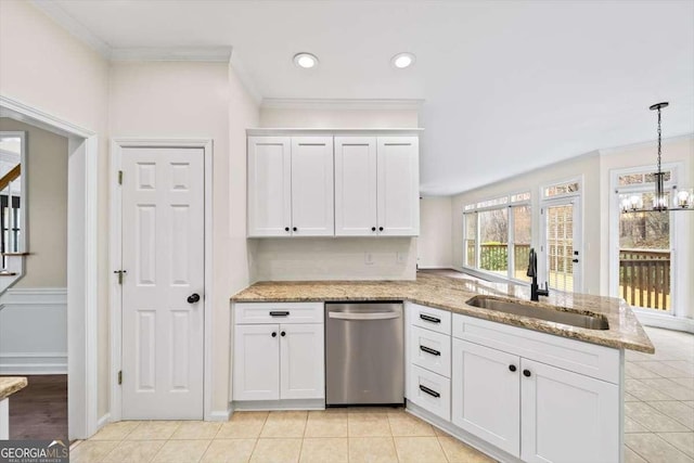 kitchen with dishwasher, hanging light fixtures, a sink, and white cabinets