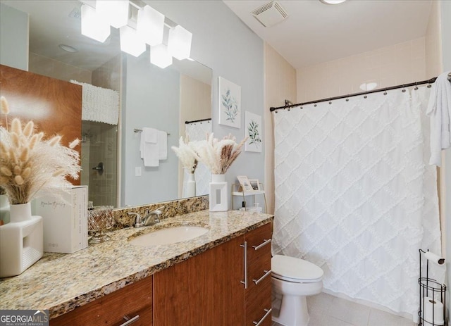bathroom with a shower with shower curtain, vanity, tile patterned floors, toilet, and visible vents