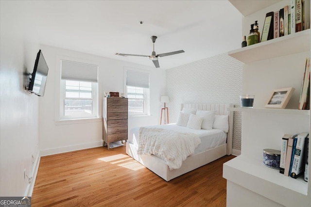 1253 Caroline St NE Unit 223, Atlanta, GA 30307 - bedroom with light wood-style floors, baseboards, an accent wall, and ceiling fan