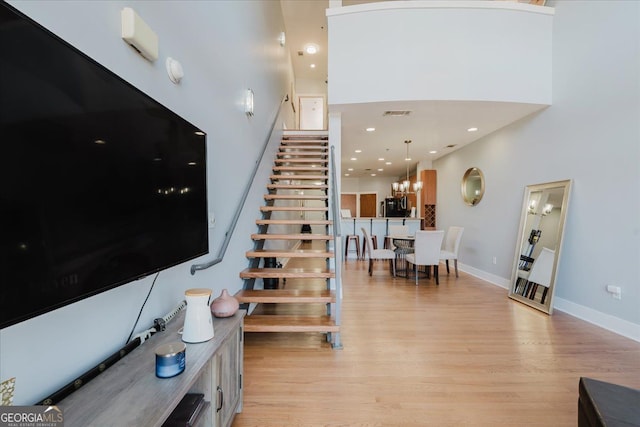 stairs featuring visible vents, baseboards, recessed lighting, and wood finished floors