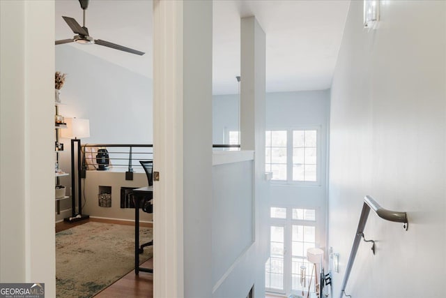 interior space with a ceiling fan and wood finished floors