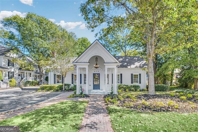 greek revival house with a front lawn