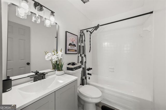 full bathroom featuring vanity, toilet, and shower / tub combo with curtain