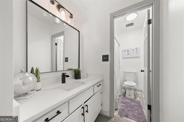 bathroom with toilet and vanity