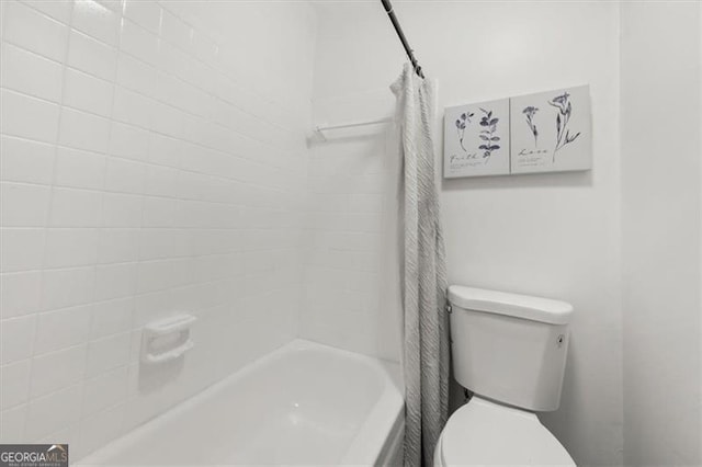 bathroom with toilet and shower / bath combo with shower curtain