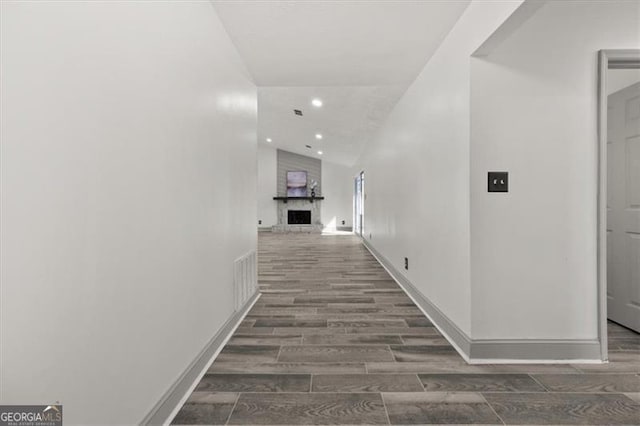 hall with baseboards, recessed lighting, and wood tiled floor