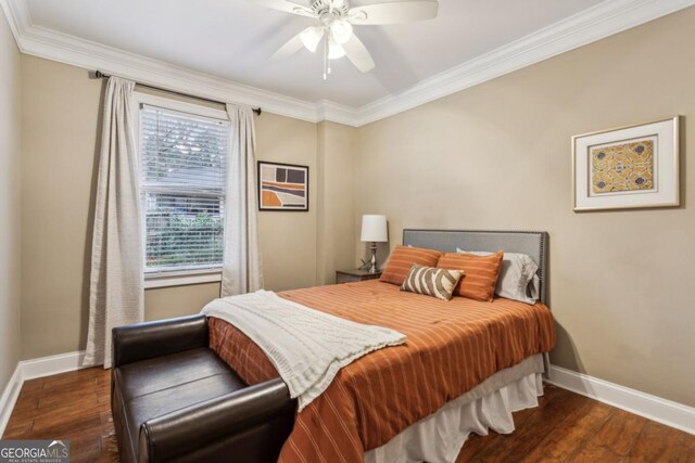 bedroom with crown molding, baseboards, and dark wood-style flooring