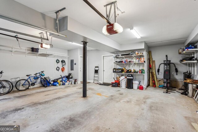 garage with electric panel and a garage door opener