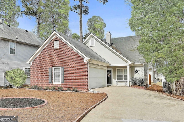 view of front of house with a garage, driveway, a chimney, roof with shingles, and brick siding