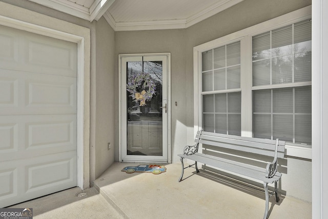 property entrance featuring a garage and stucco siding