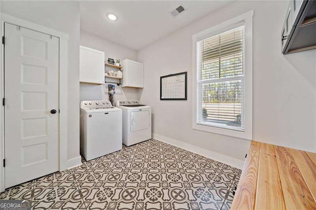 laundry room with cabinet space, baseboards, visible vents, and separate washer and dryer