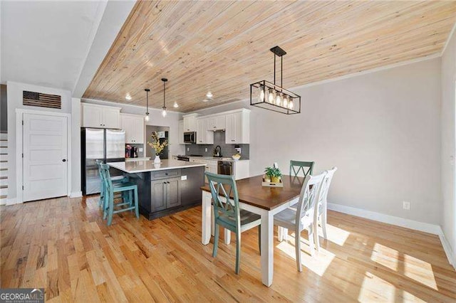 dining room with baseboards, wooden ceiling, an inviting chandelier, crown molding, and light wood-type flooring