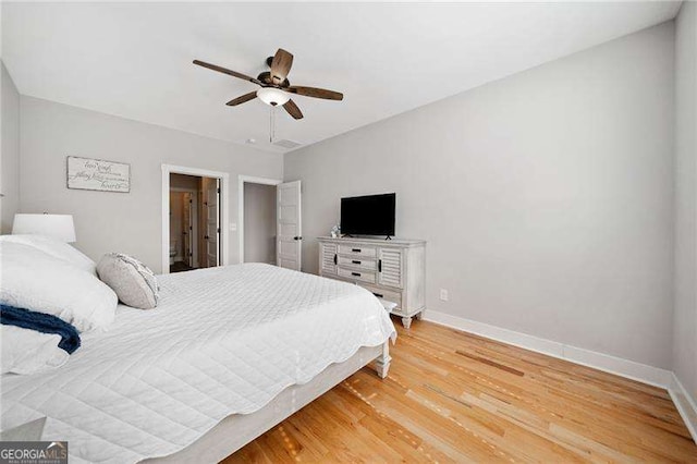 bedroom with light wood-type flooring, baseboards, and a ceiling fan