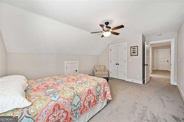 bedroom with baseboards, a ceiling fan, vaulted ceiling, carpet flooring, and a closet