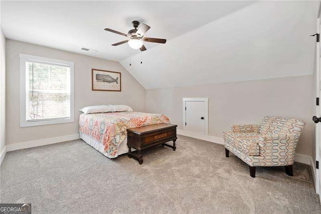 bedroom with carpet floors, visible vents, vaulted ceiling, ceiling fan, and baseboards