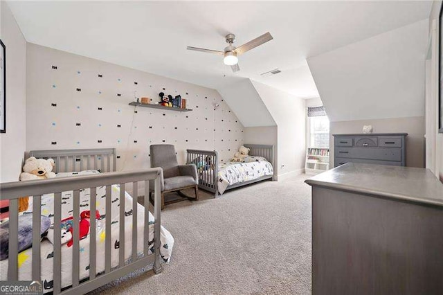 bedroom with lofted ceiling, carpet, visible vents, and a ceiling fan