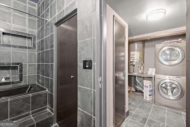 bathroom featuring a washtub and stacked washer / drying machine