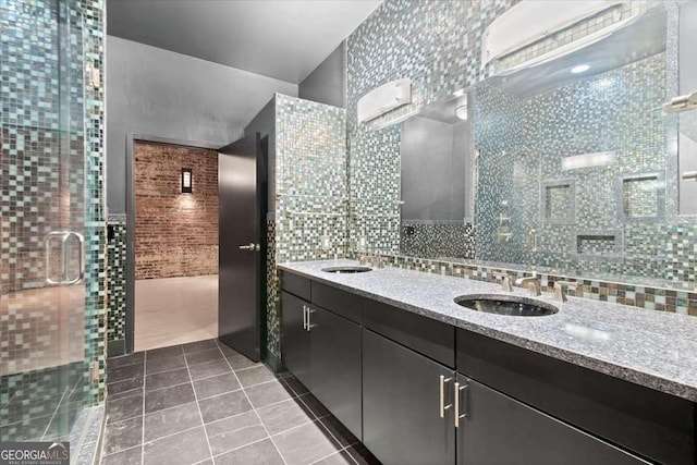 full bathroom featuring double vanity, a sink, tile walls, and tile patterned floors