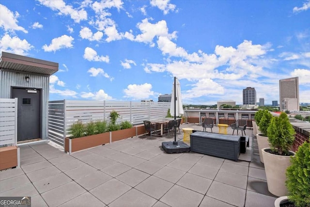 view of patio featuring a view of city and outdoor dining area