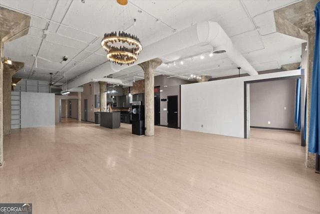 interior space featuring an inviting chandelier and wood finished floors