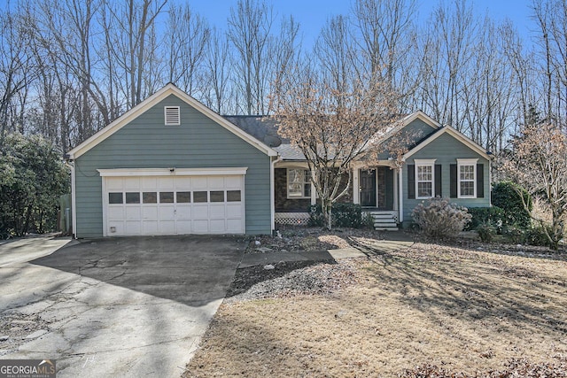 ranch-style house with a garage, stone siding, and driveway