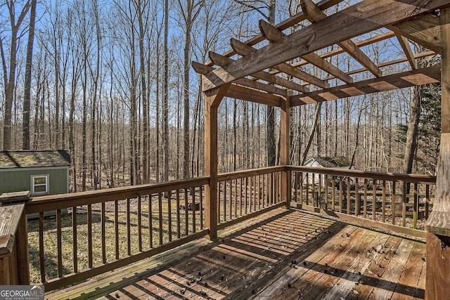 deck featuring an outbuilding and a pergola