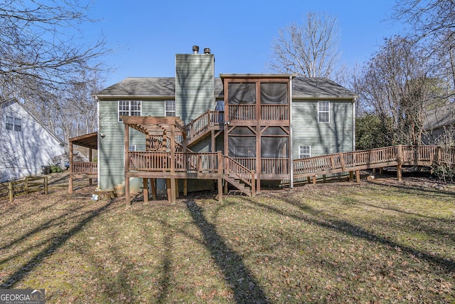 rear view of house featuring a chimney, a lawn, a sunroom, fence, and a pergola