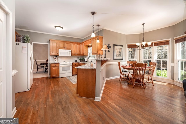 kitchen featuring white appliances, dark wood finished floors, brown cabinetry, a peninsula, and light stone countertops