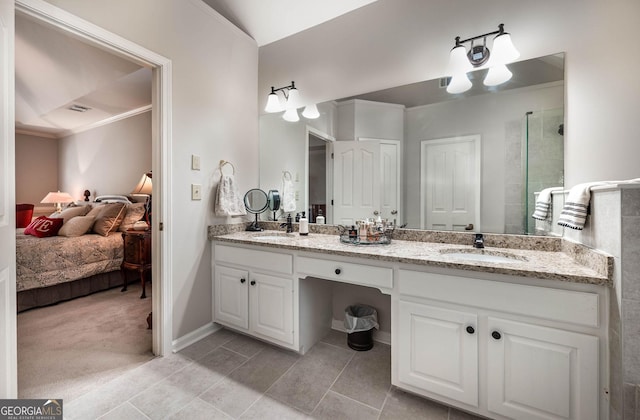 bathroom featuring ensuite bathroom, double vanity, ornamental molding, and a sink