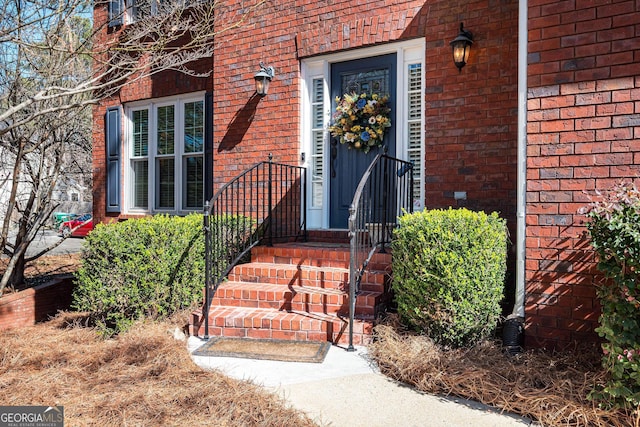 view of exterior entry with brick siding