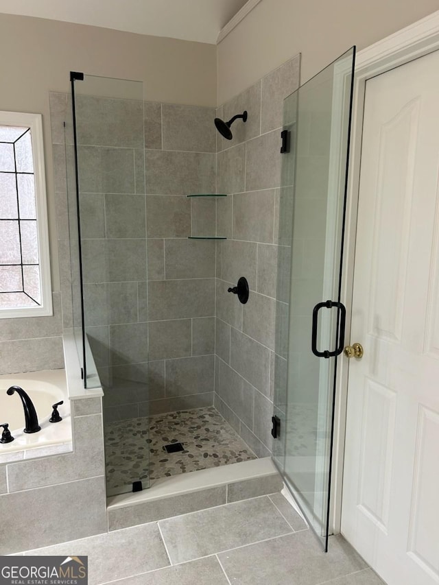 full bath with tile patterned floors, a shower stall, and a bath